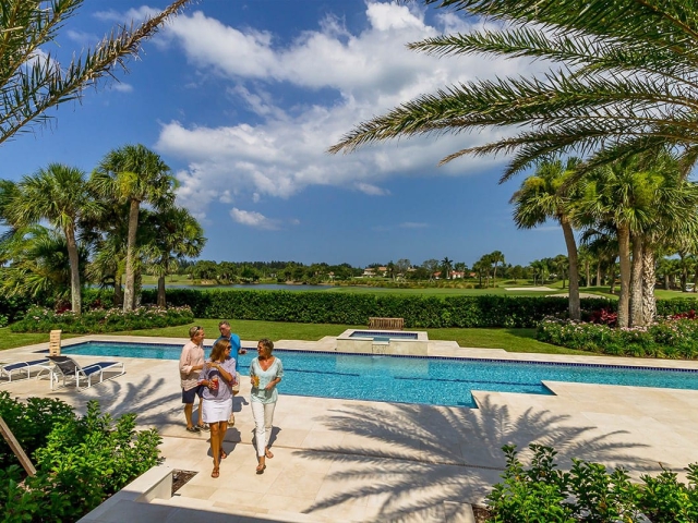 2 couples enjoying a backyard pool at Orchid Island