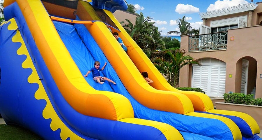 Kids plan on a large, blow-up slip 'n' slide in the Orchid Island Beach Club courtyard.