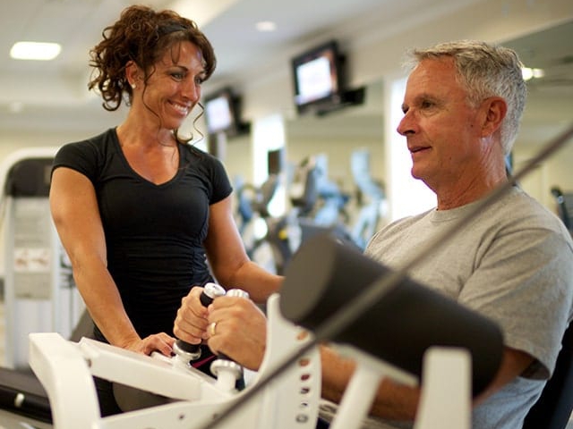 Man works out with personal trainer at the Orchid Island Fitness Center