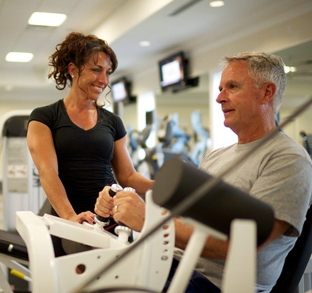 Man works out with personal trainer at the Orchid Island Fitness Center