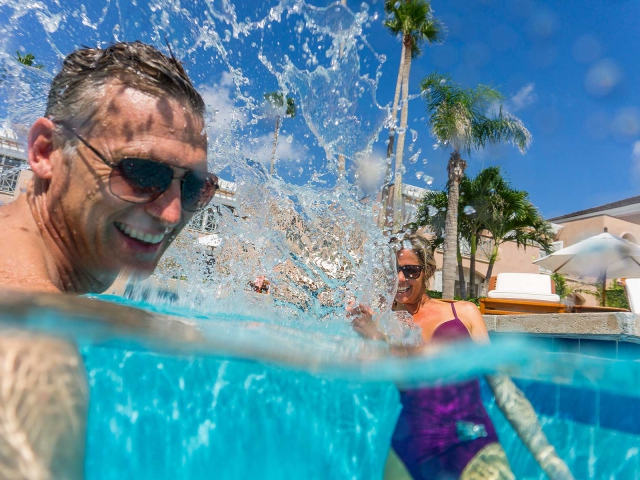 Two adults splashing in Orchid Island Pool