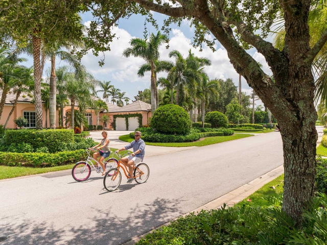 Couple riding bikes in Orchid Island neighborhood