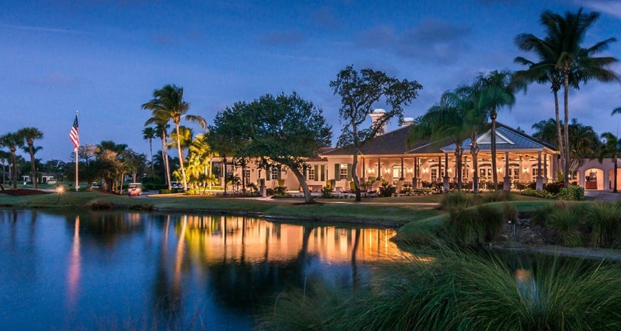 Nighttime view of the Orchid Island Golf Clubhouse, overlooking the water.