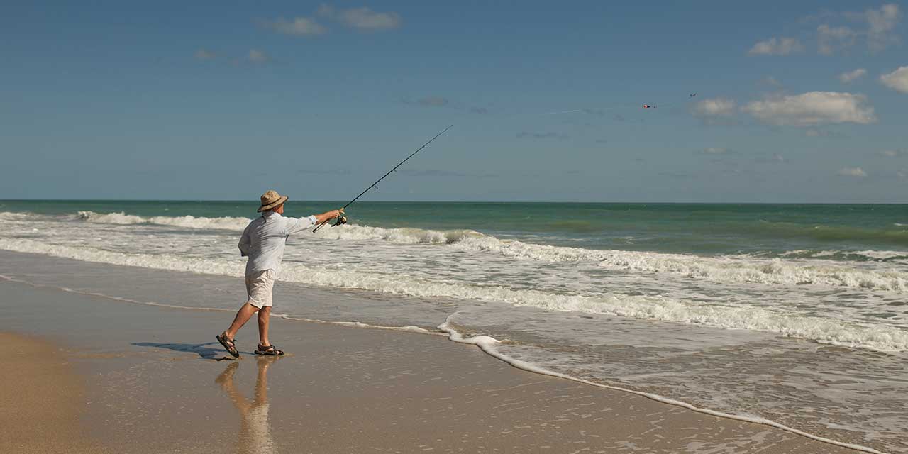 Man fishing on the beach at Orchid Island