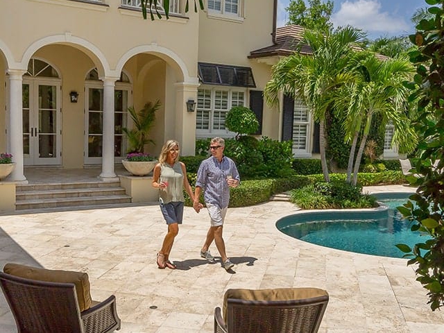 A couple hand in hand walking outdoors at Orchid Island Vero Beach
