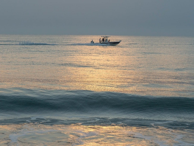 Boat on the calm ocean at Orchid Island as sun sets