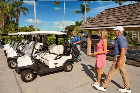 couple walking to parked golf carts at orchid