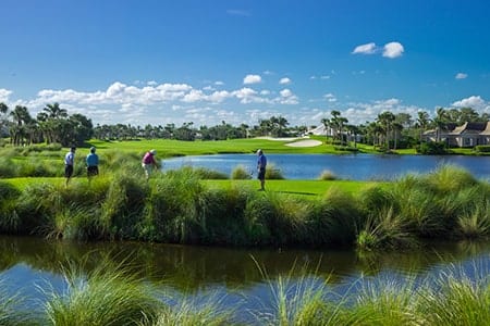 A group for 4 golfers tee-off on one of the holes at Orchid Island's golf course.
