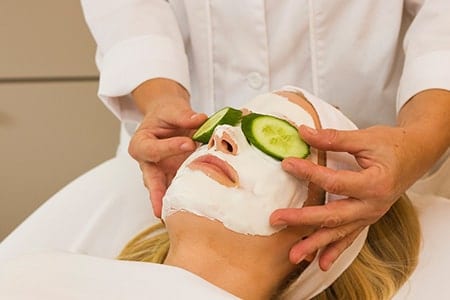 Woman getting a facial at Orchid Island's spa.