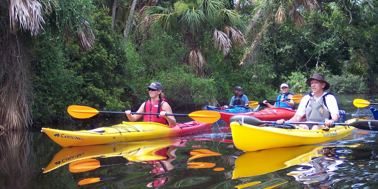 Group of friends kayaking along the Indian River in Vero Beach, FL.