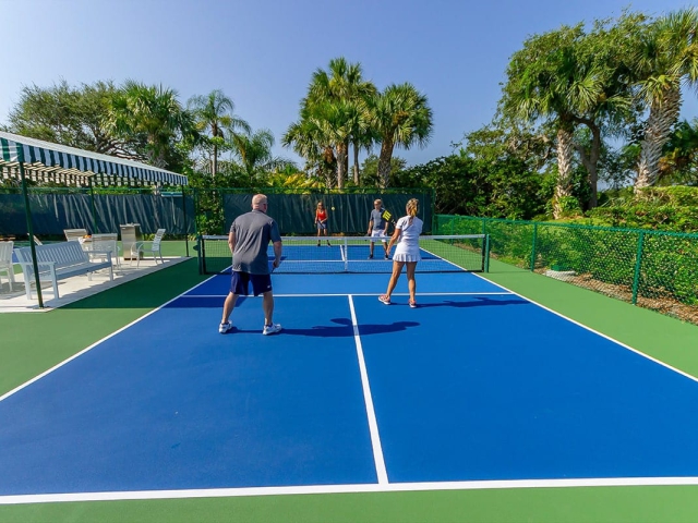 Friends playing Pickleball at Orchid Island courts