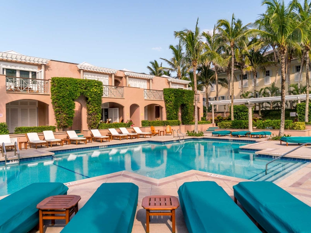 Pool with teak lounge chairs surrounding Orchid Island Pool at the Clubhouse