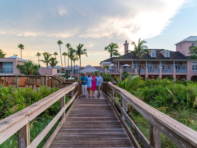 Friends walking down Boardwalk at Orchid Island