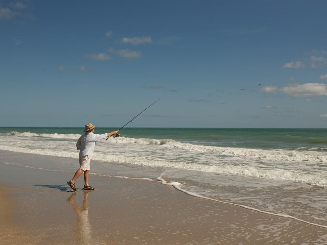 Man fishing on the beach at Orchid Island