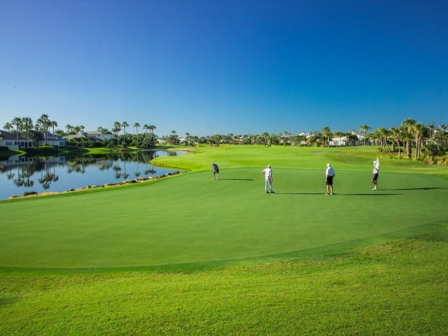 Golfers on the green at Orchid Island Golf Course