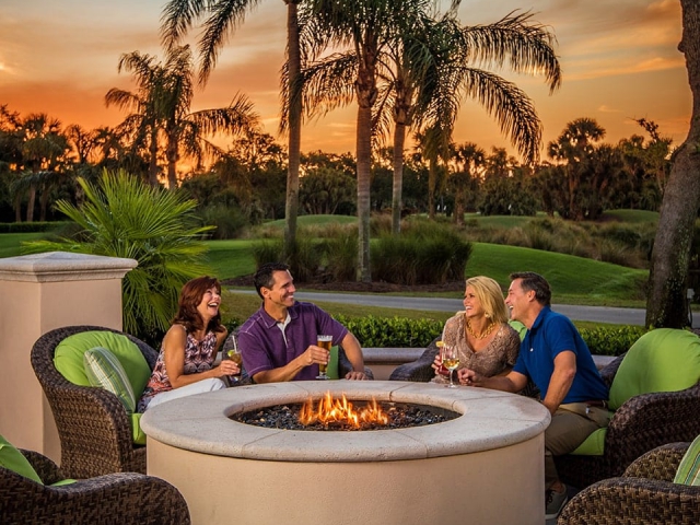 Two couples enjoying Orchid Island Firepit at Sunset