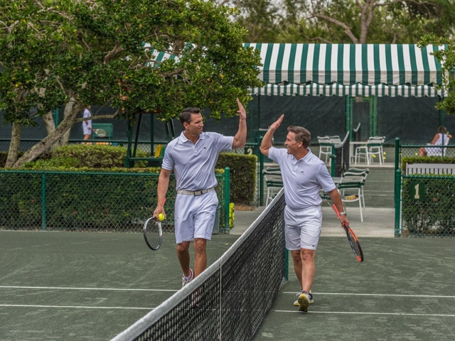 Orchid Island Tennis Club with two men giving each other high five
