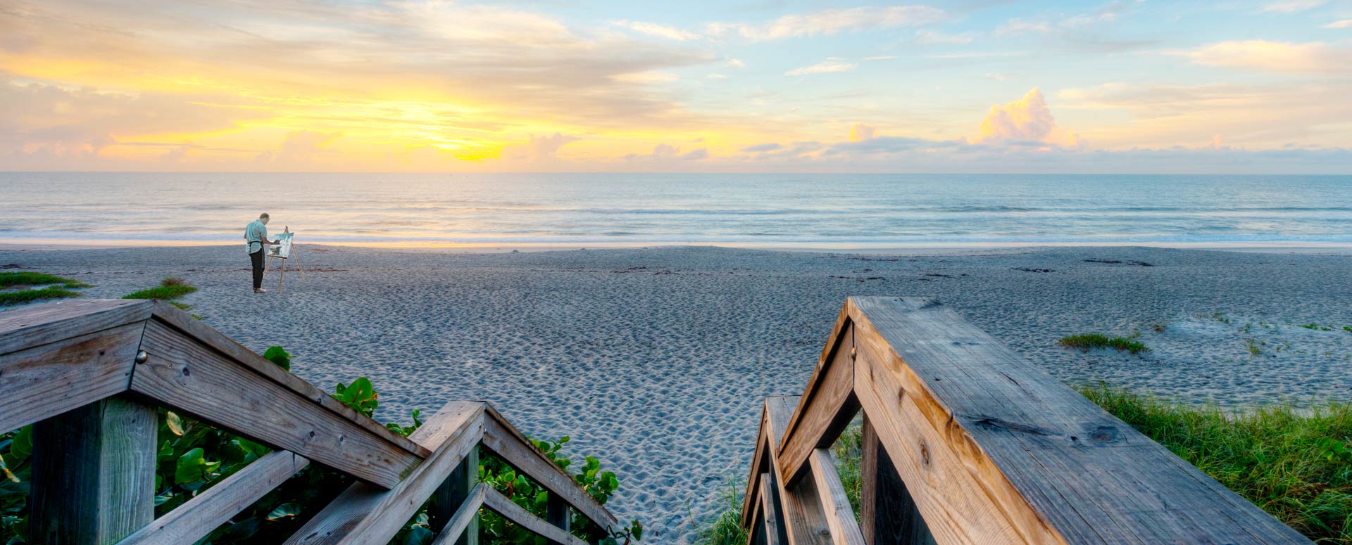 orchid island member painting the sunset over the beach