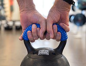 Bill holding a kettle bell at orchid island fitness center