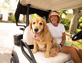 mary and her dog on a golf cart