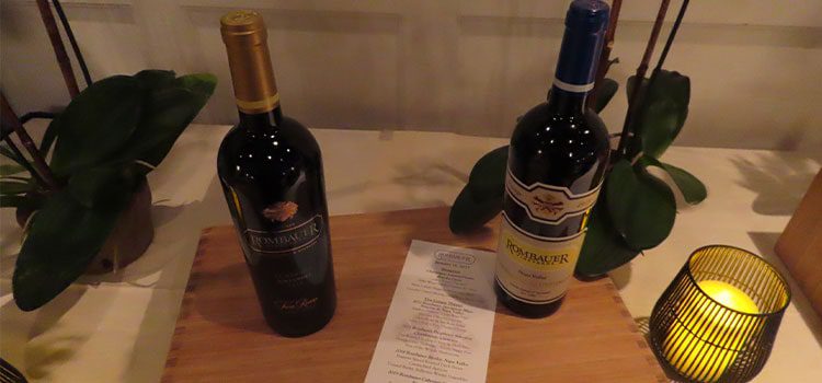 two wine bottles on table with menu