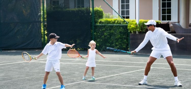 Family playing tennis at Orchid Island
