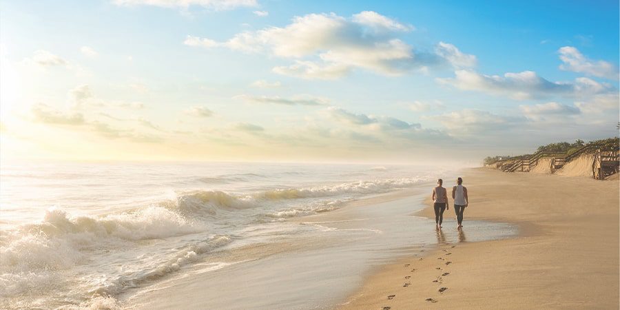 Vero Beach couple walking in sand