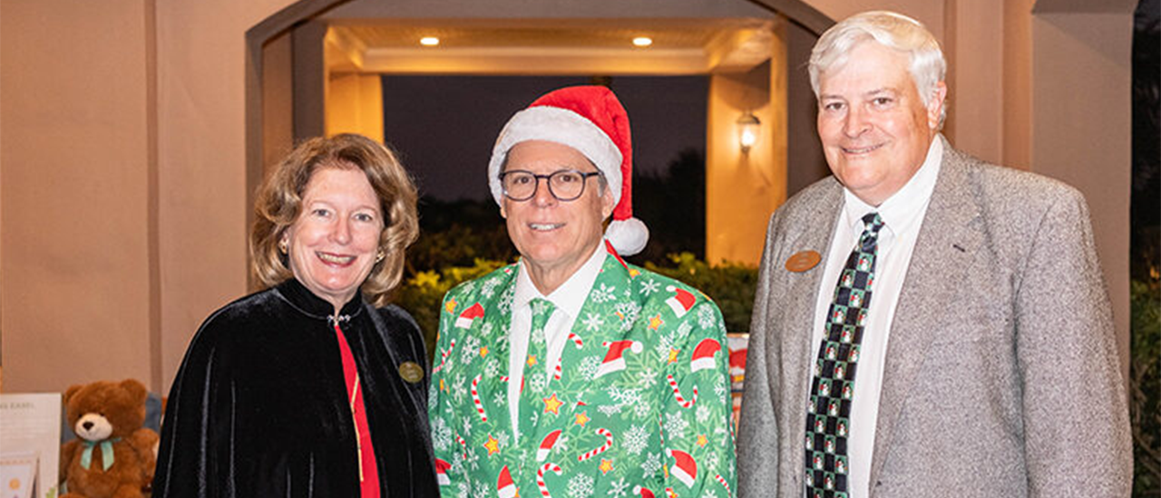 Orchid Island holiday charity event, one wearing a green Christmas suit and Santa hat.