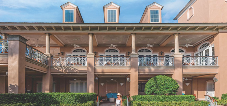 Beach club building with covered terrace and landscaped lawn