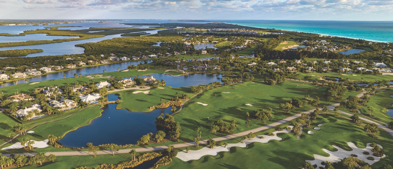Aerial view of coastal residential community with waterways and shoreline